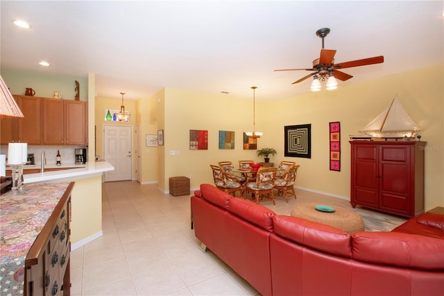 living room with ceiling fan and light tile patterned floors