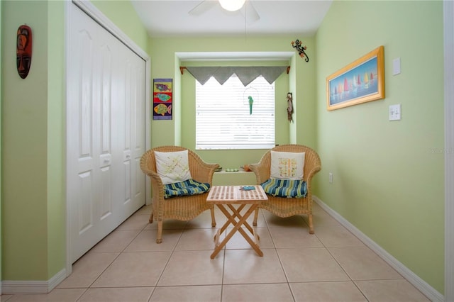 sitting room featuring ceiling fan and light tile patterned floors