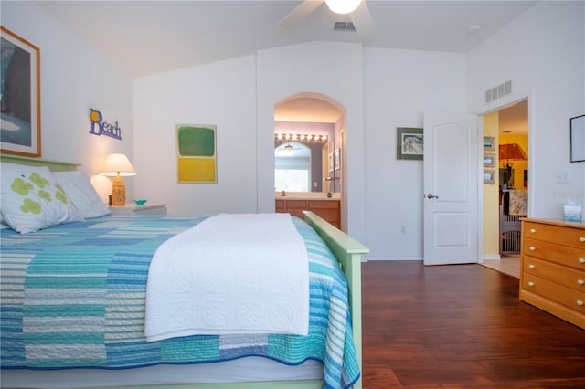 bedroom featuring dark wood-type flooring, ceiling fan, ensuite bathroom, and vaulted ceiling