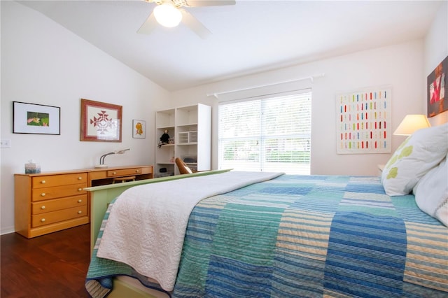 bedroom with ceiling fan, vaulted ceiling, and dark hardwood / wood-style flooring