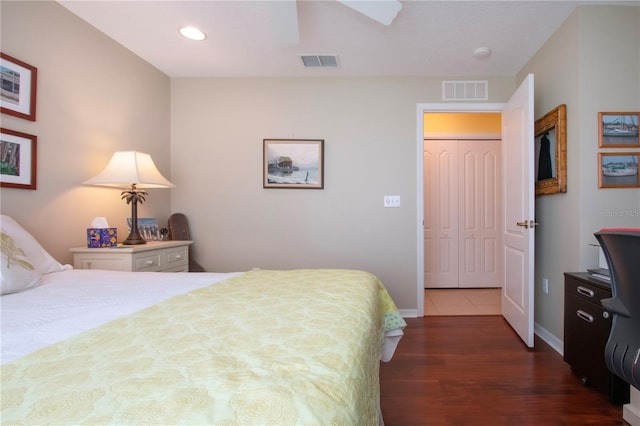 bedroom featuring dark wood-type flooring, a closet, and ceiling fan