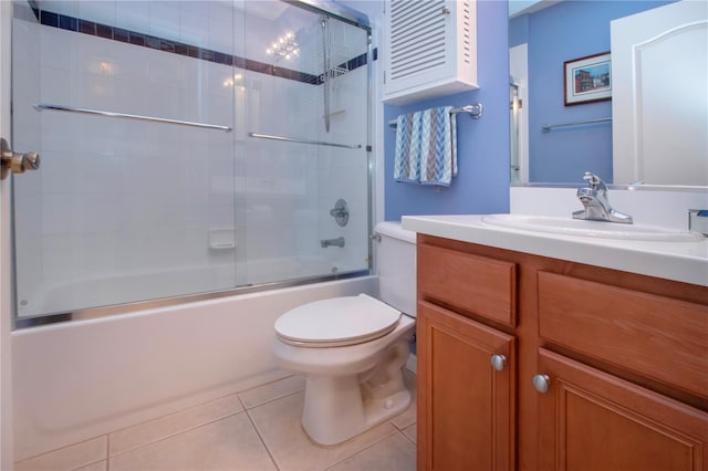 full bathroom featuring toilet, bath / shower combo with glass door, vanity, and tile patterned floors