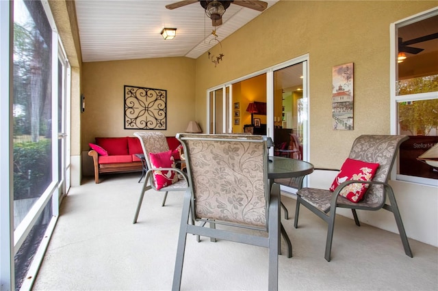 sunroom / solarium featuring ceiling fan and vaulted ceiling