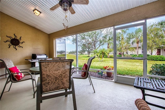 sunroom / solarium with ceiling fan and lofted ceiling