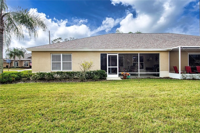 back of property featuring a yard and a sunroom