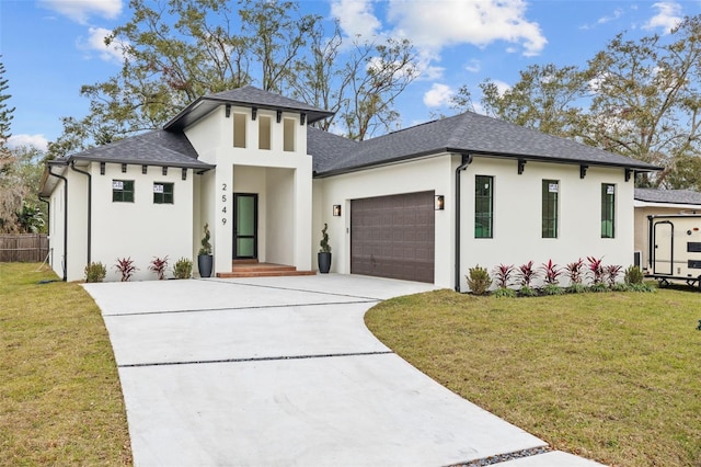 prairie-style house featuring a front yard and a garage