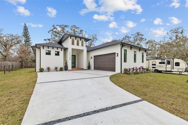 view of front of property featuring a garage and a front lawn