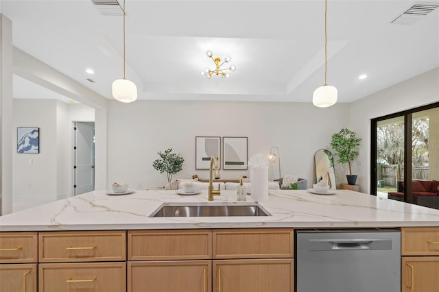 kitchen featuring pendant lighting, dishwasher, a kitchen island with sink, and sink