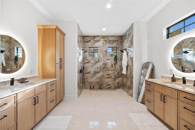 bathroom featuring a tile shower and vanity