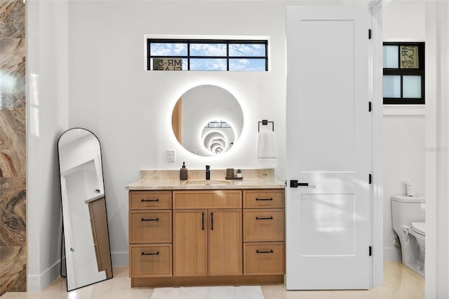 bathroom featuring toilet, vanity, and tile patterned flooring