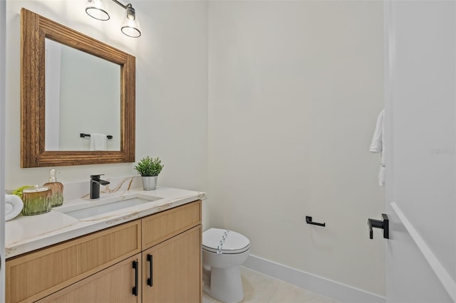 bathroom featuring tile patterned floors, vanity, and toilet