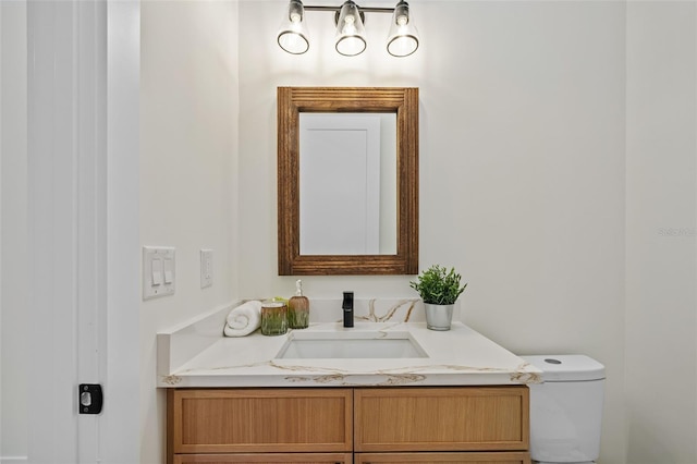 bathroom with toilet and vanity