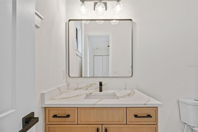 bathroom featuring toilet and vanity