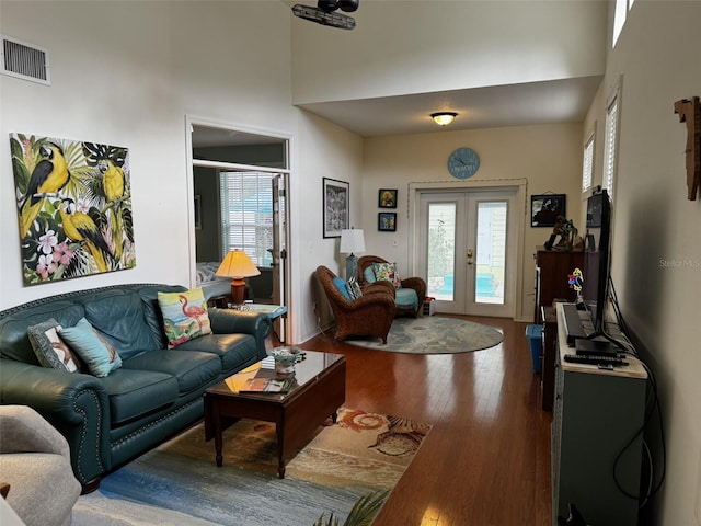 living room featuring hardwood / wood-style flooring, a wealth of natural light, and french doors