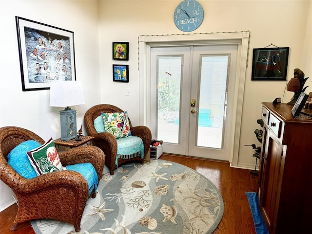 living area with hardwood / wood-style flooring and french doors