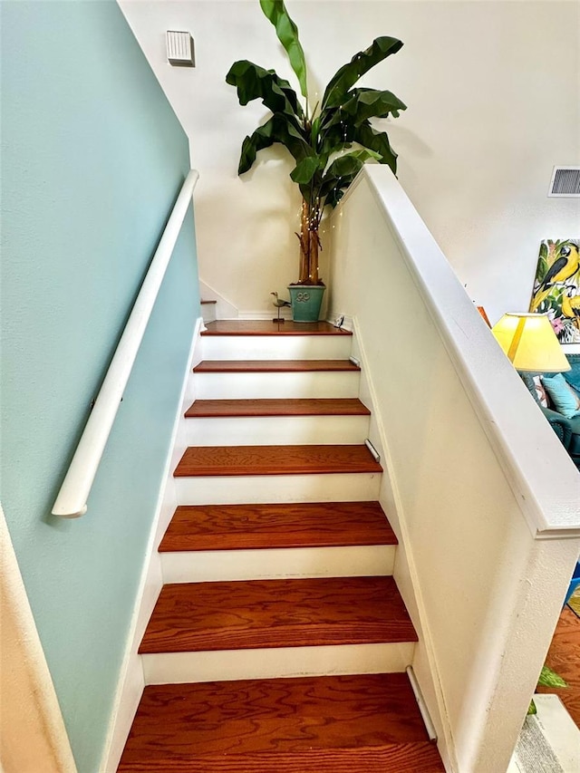 stairway featuring hardwood / wood-style floors