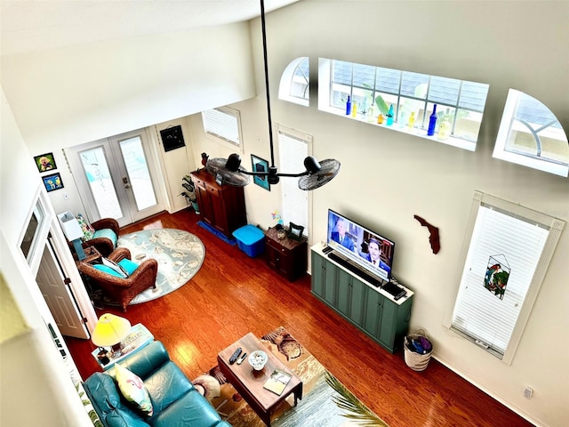 living room featuring french doors, dark hardwood / wood-style floors, and a high ceiling