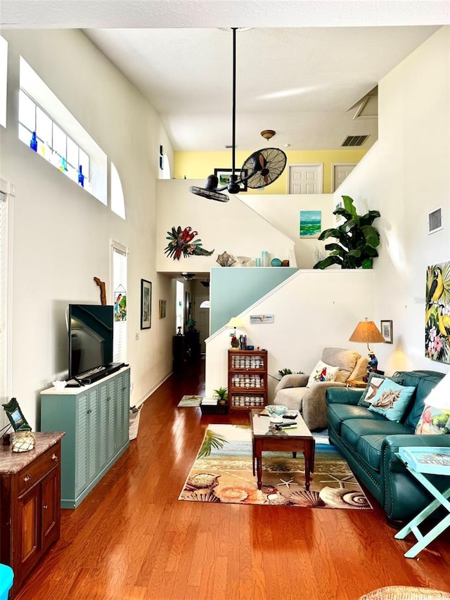 living room featuring hardwood / wood-style floors, a high ceiling, and a wealth of natural light