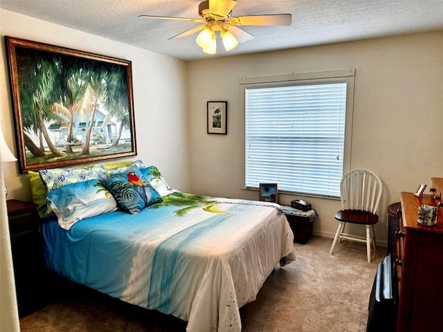 carpeted bedroom with a textured ceiling and ceiling fan