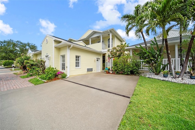 458 Grant St, Dunedin, FL 34698 - view of front of home with concrete driveway, a porch, and a front yard