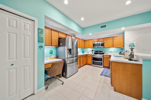 458 Grant St, Dunedin, FL 34698 - kitchen with stainless steel appliances, light countertops, a sink, recessed lighting, and light tile patterned floors
