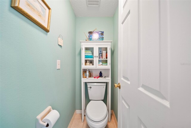 458 Grant St, Dunedin, FL 34698 - bathroom with toilet, a textured ceiling, and tile patterned floors