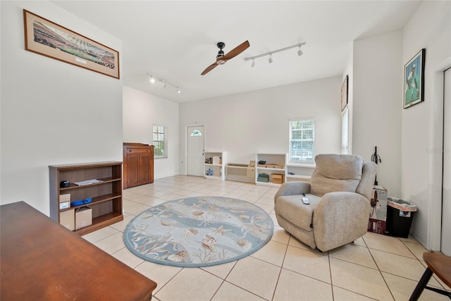 458 Grant St, Dunedin, FL 34698 - living area featuring rail lighting, light tile patterned floors, ceiling fan, and healthy amount of natural light