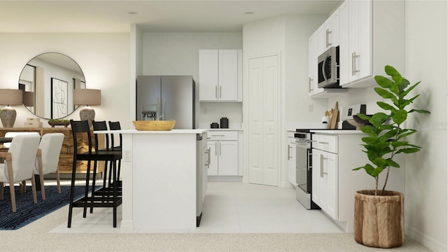 kitchen with white cabinets, light tile patterned flooring, stainless steel appliances, and a center island