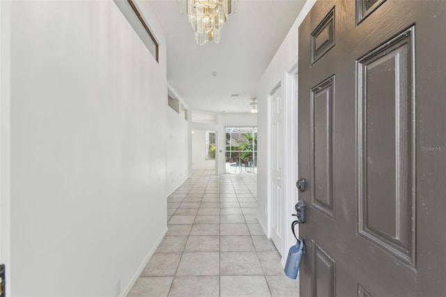 tiled foyer entrance featuring a chandelier