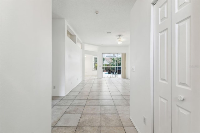 hall featuring light tile patterned floors