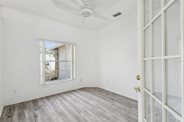 empty room featuring ceiling fan and light hardwood / wood-style flooring