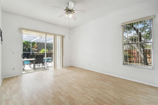 spare room featuring a textured ceiling, ceiling fan, and light hardwood / wood-style flooring