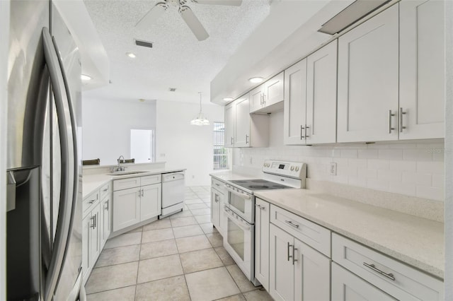 kitchen featuring white appliances, white cabinets, a textured ceiling, sink, and backsplash