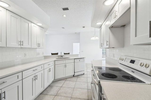 kitchen with tasteful backsplash, white appliances, pendant lighting, white cabinets, and sink