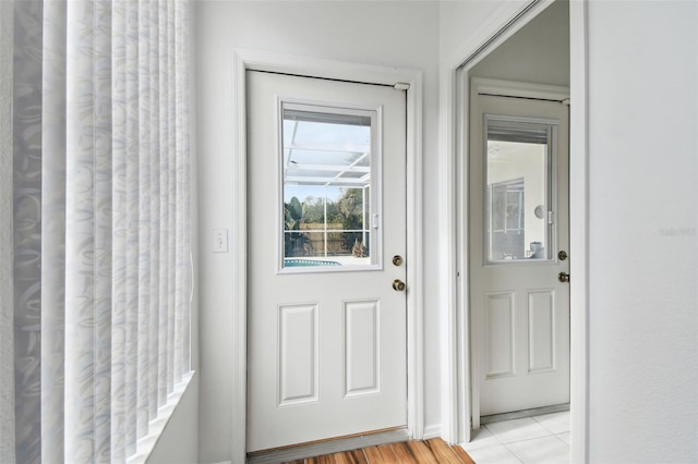 doorway with light tile patterned floors