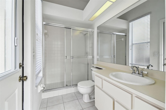 bathroom with an enclosed shower, vanity, tile patterned flooring, and toilet