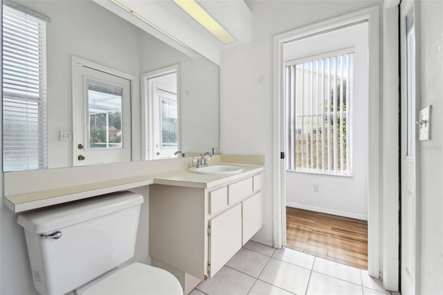 bathroom featuring tile patterned floors, vanity, and toilet