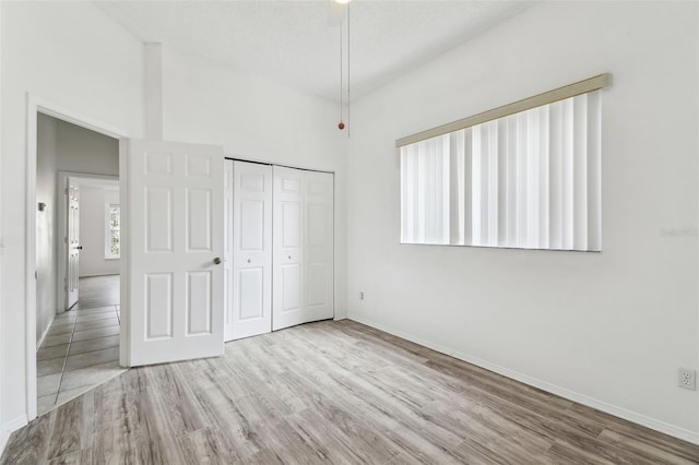 unfurnished bedroom with a closet and light hardwood / wood-style flooring