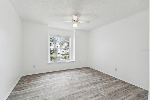 unfurnished room featuring ceiling fan, light hardwood / wood-style floors, and a textured ceiling