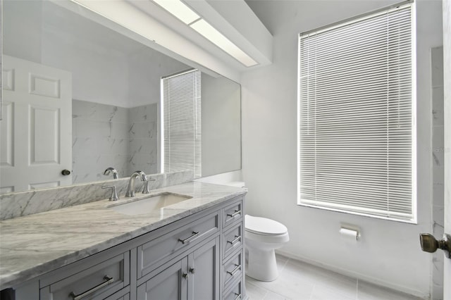 bathroom featuring toilet, tile patterned floors, and vanity