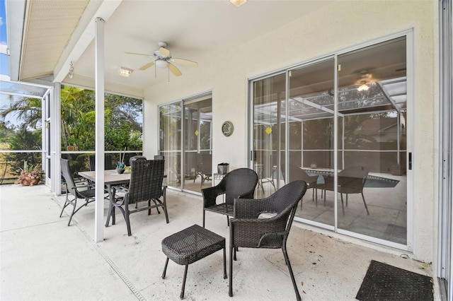 sunroom featuring ceiling fan