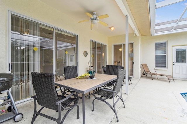 view of patio / terrace with ceiling fan and a lanai