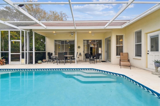 view of pool with a lanai, ceiling fan, and a patio area