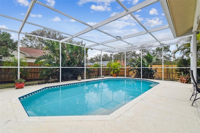 view of swimming pool featuring a lanai and a patio