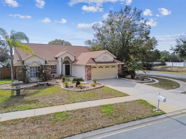 view of front of property featuring a garage and a front lawn