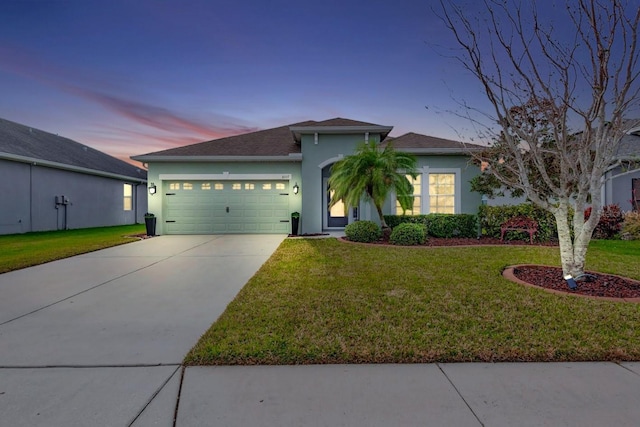 view of front of house with a lawn and a garage