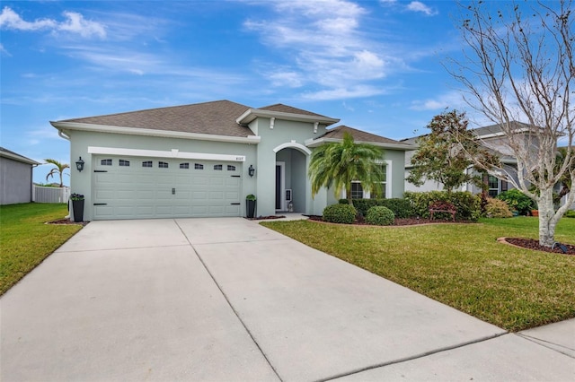 view of front of home with a front lawn and a garage