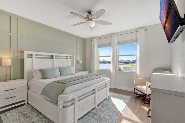 bedroom featuring ceiling fan and light hardwood / wood-style flooring