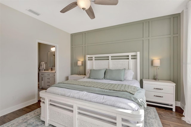 bedroom featuring ceiling fan, connected bathroom, and hardwood / wood-style flooring