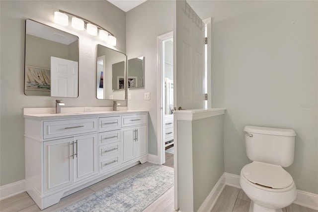 bathroom with toilet and vanity